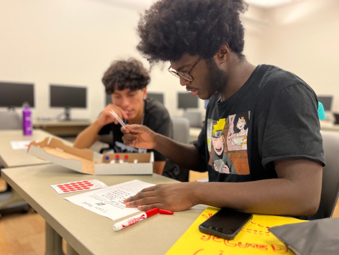 Cybersecurity Academy Two high school students doing a hands on simulation of cybersecurity protection planning