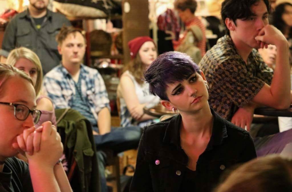 an audience paying attention to an open mic reader