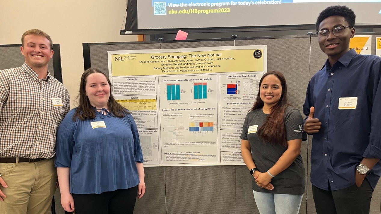 Heather Bullen Summer Celebration of Research Research students smile in front of their research poster at a research celebration event.