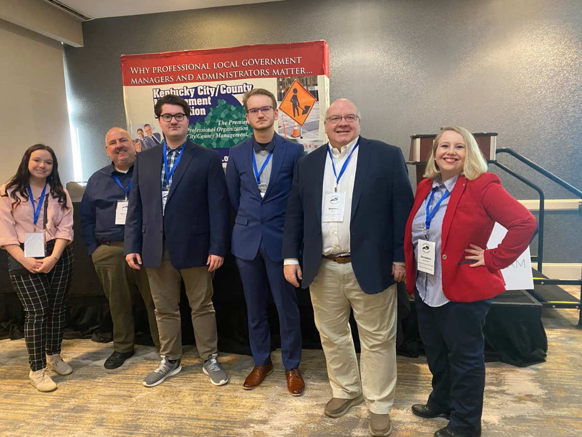 Untitled design - 1 Mallory with group from conference