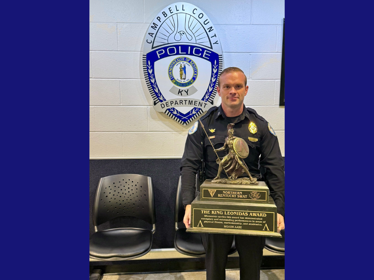 Untitled design - 1 Chris Lauer standing with his large trophy