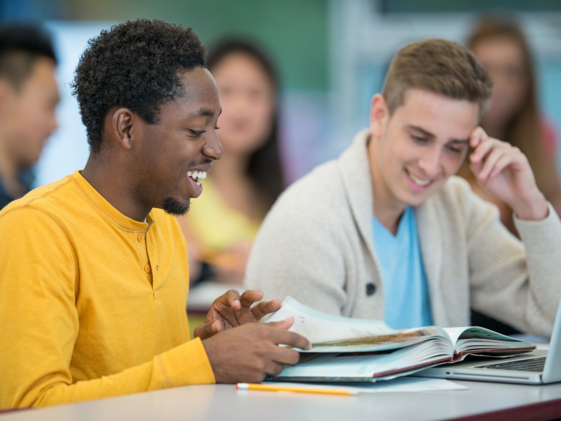 Sociology students smiling together in classroom