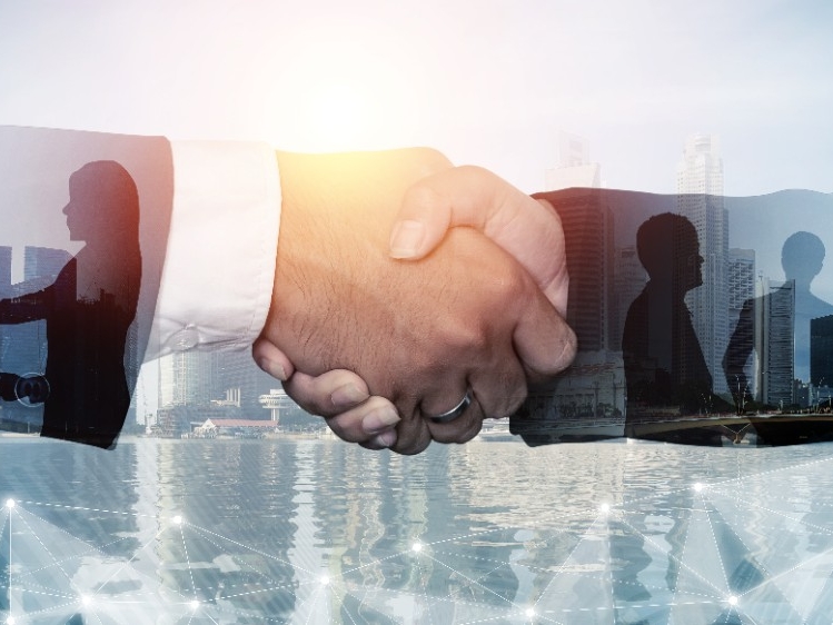 Abstract image of many business people together in group on background of city Image of a handshake